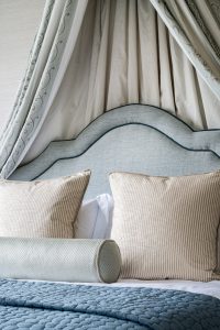 Blue hues add a feeling of calm to this serene and tranquil master suite. We designed a bespoke bed canopy with extra large scatter cushions for a sumptuous finish.