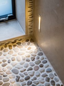 pebbled shower floor and bespoke lighting