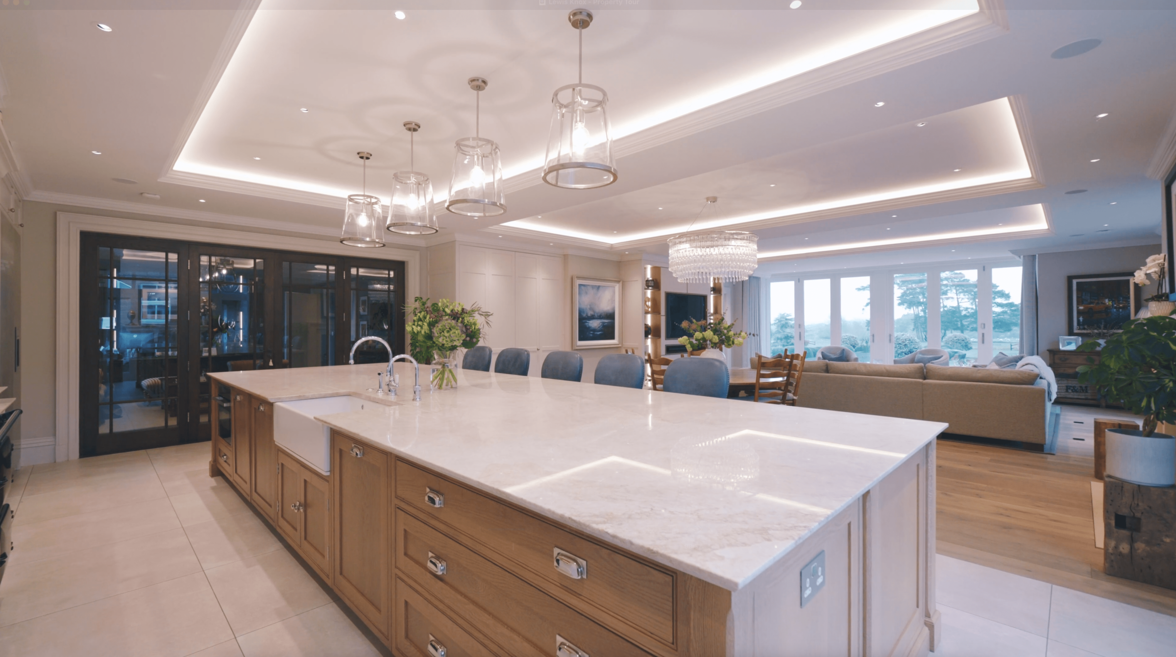 Large kitchen island with marble countertop in open plan kitchen