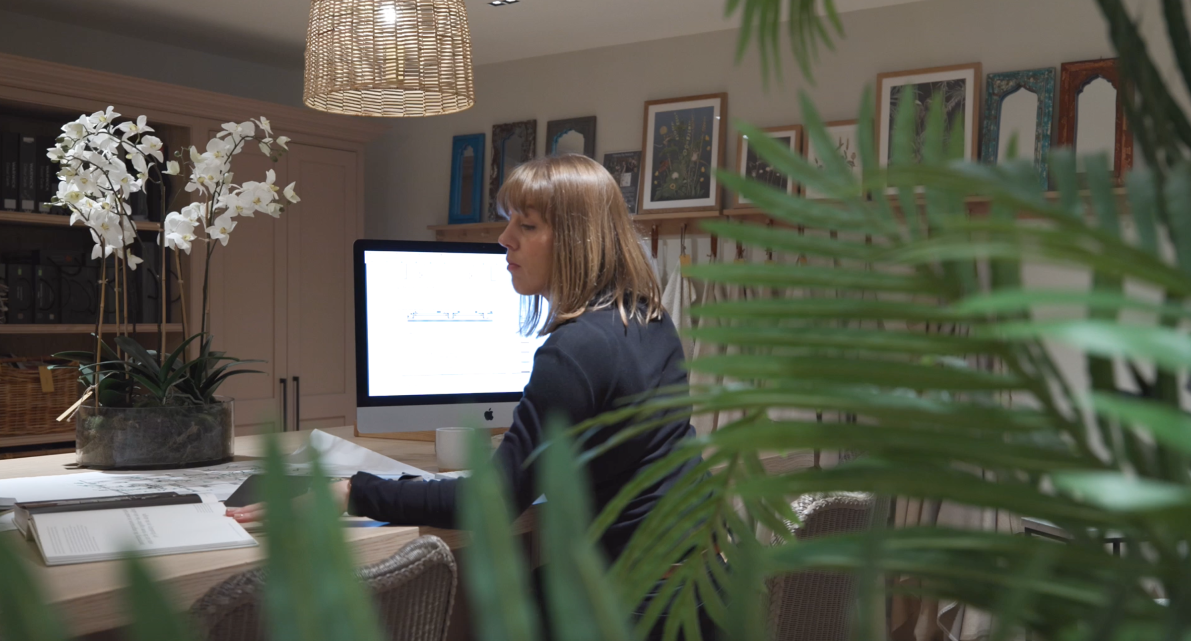 Helen looking over designs on her computer