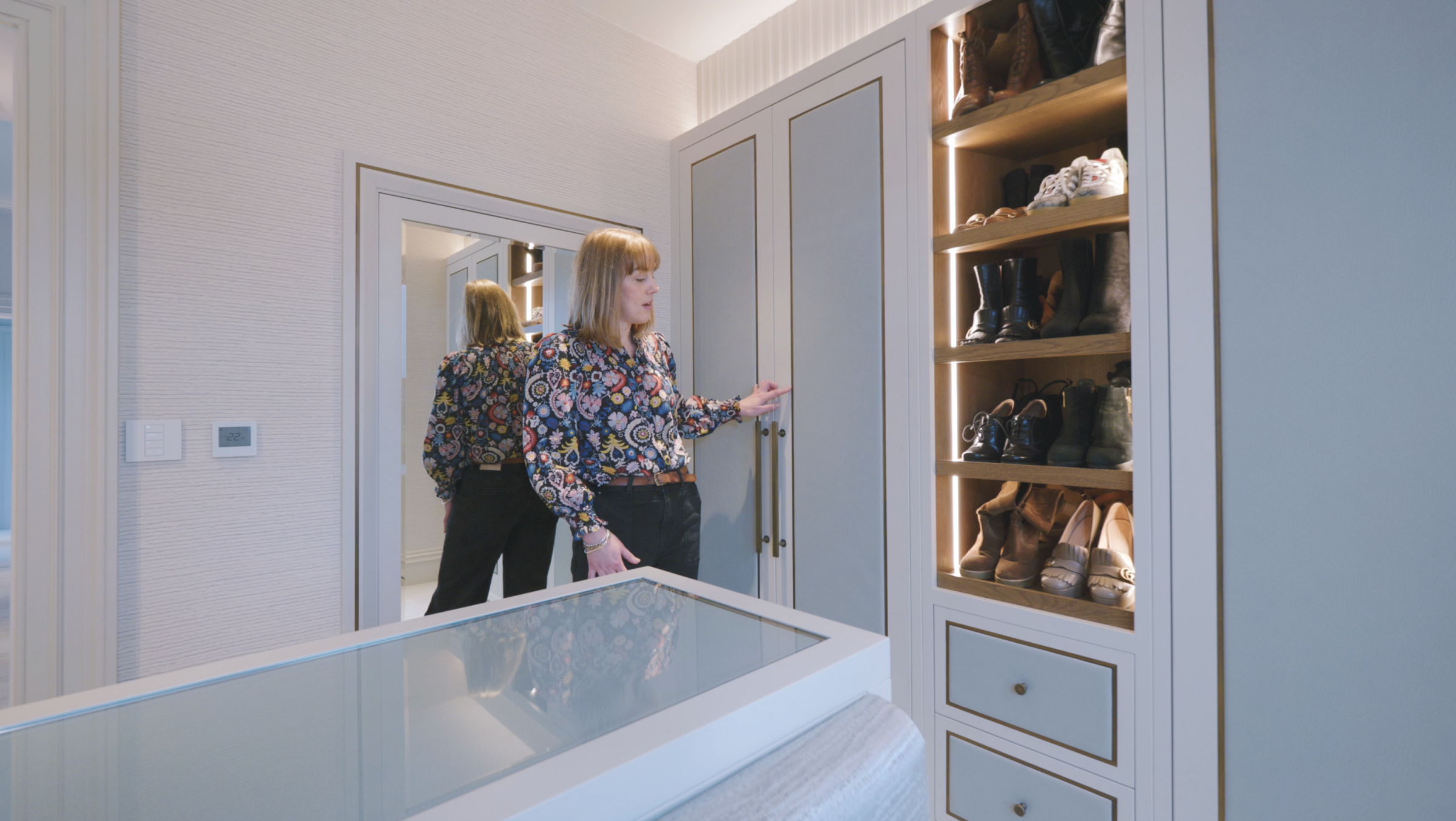 Helen in the dressing room looking at the blue wardrobe detailing