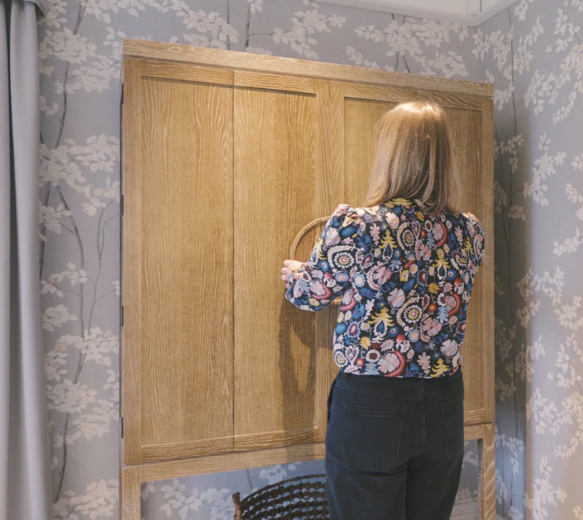 Helen opening a bespoke storage unit in the master bedoom