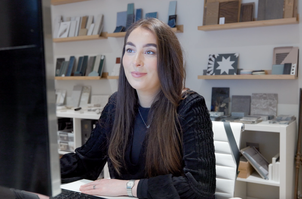 Interior designer working on virtual design plans using software at a computer