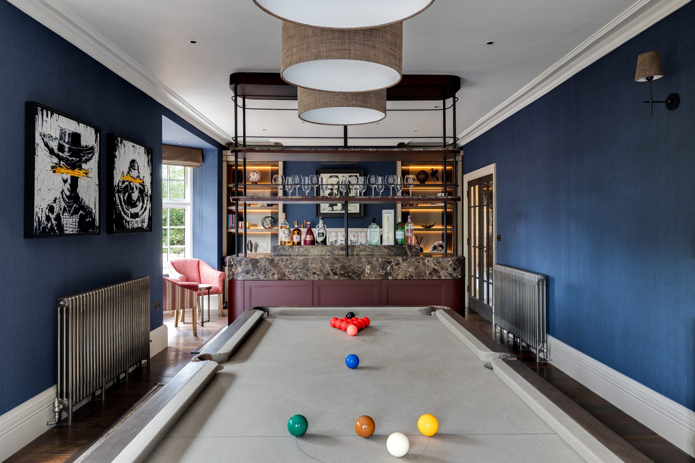 Games room with bespoke bar, blue grasscloth walls and full-size pool table