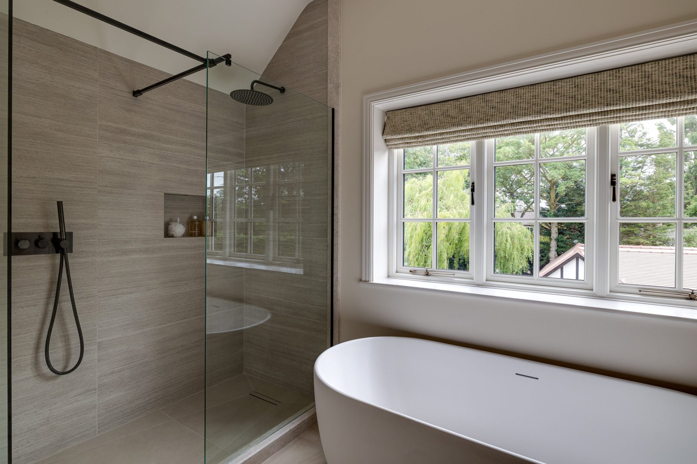 Walk-in shower with full-height tiling and recessed niche in neutral tones