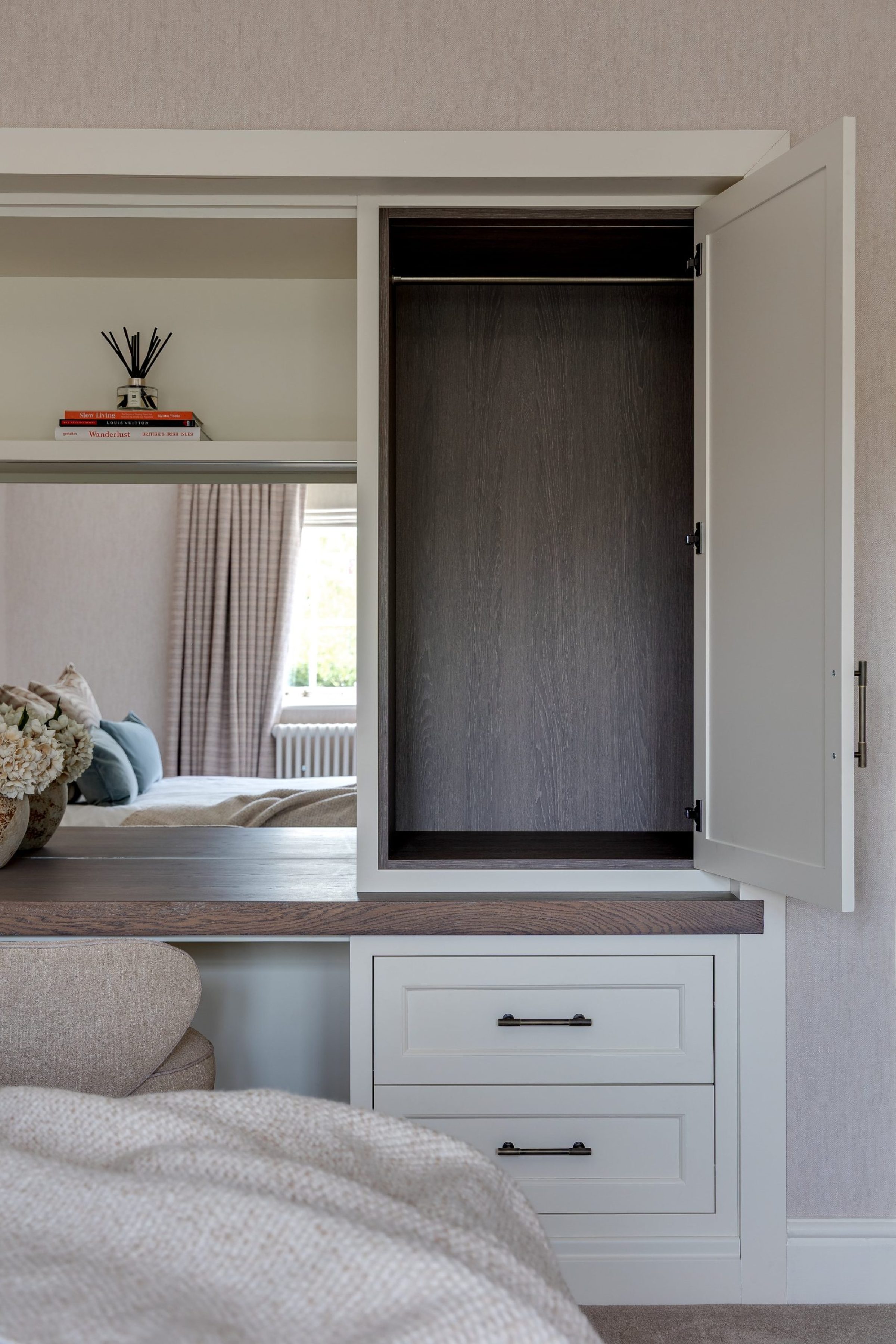 Guest bedroom dressing area with integrated storage and oak-topped vanity