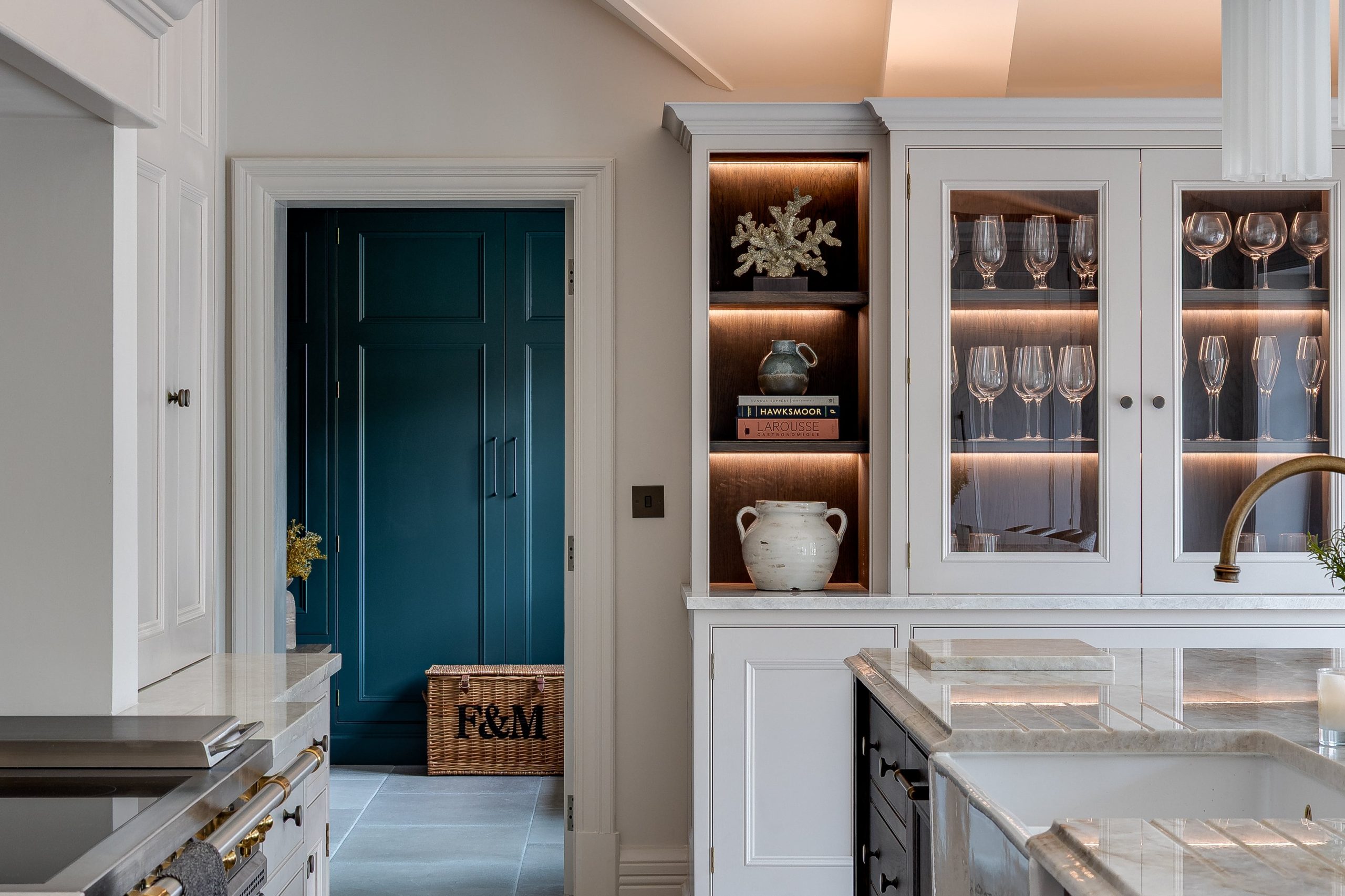 Kitchen joinery with view through to deep blue boot room cabinetry