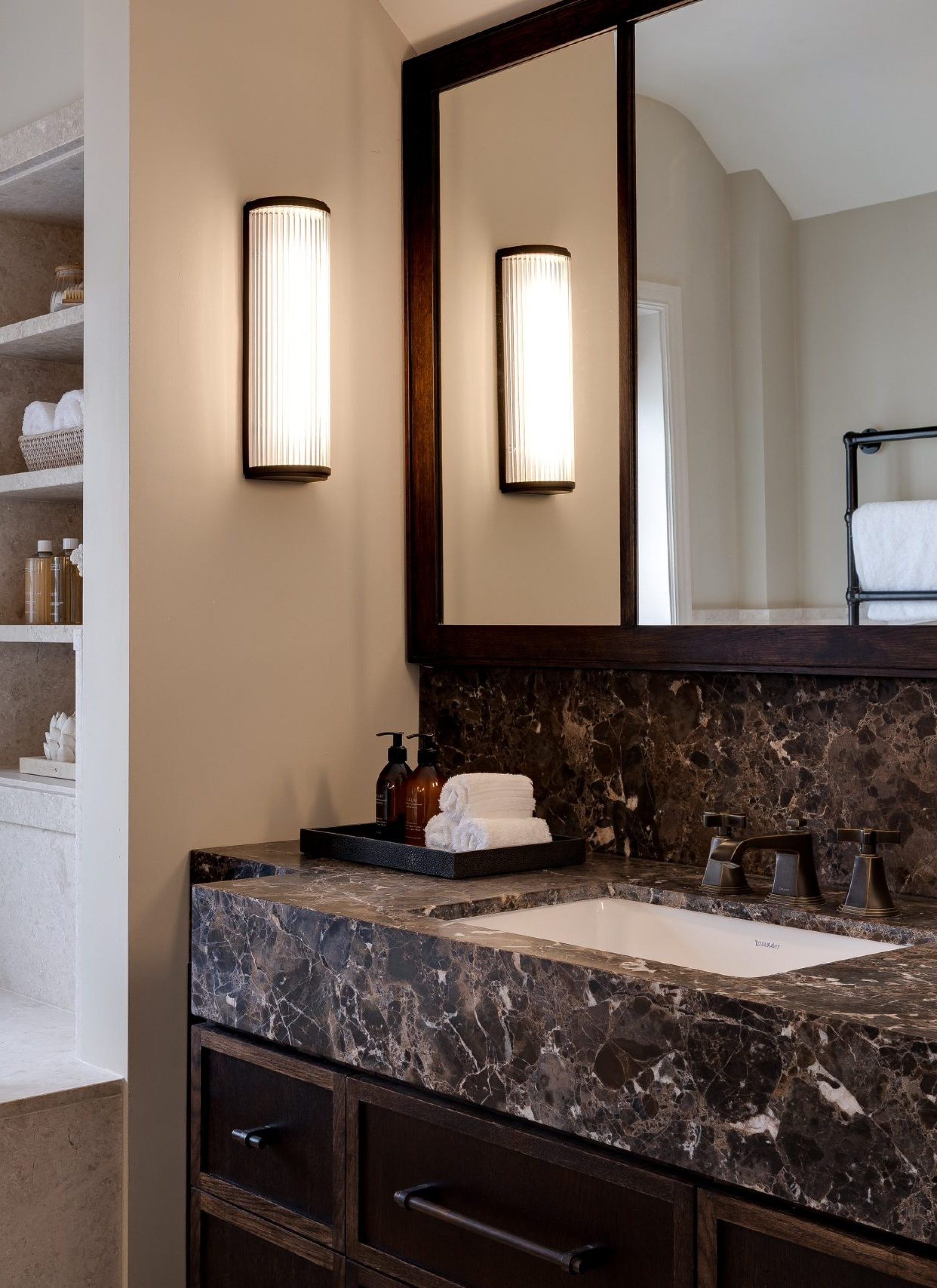 Master bathroom with marble vanity, double mirror and built-in stone bath surround