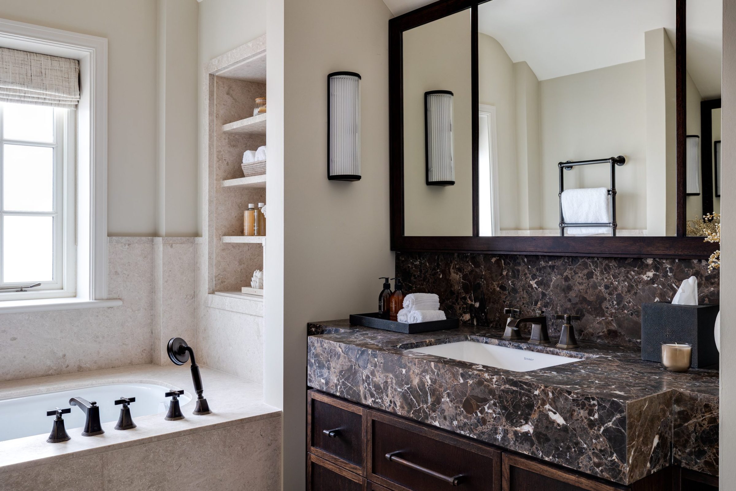 Master bathroom with marble vanity, double mirror and built-in stone bath surround