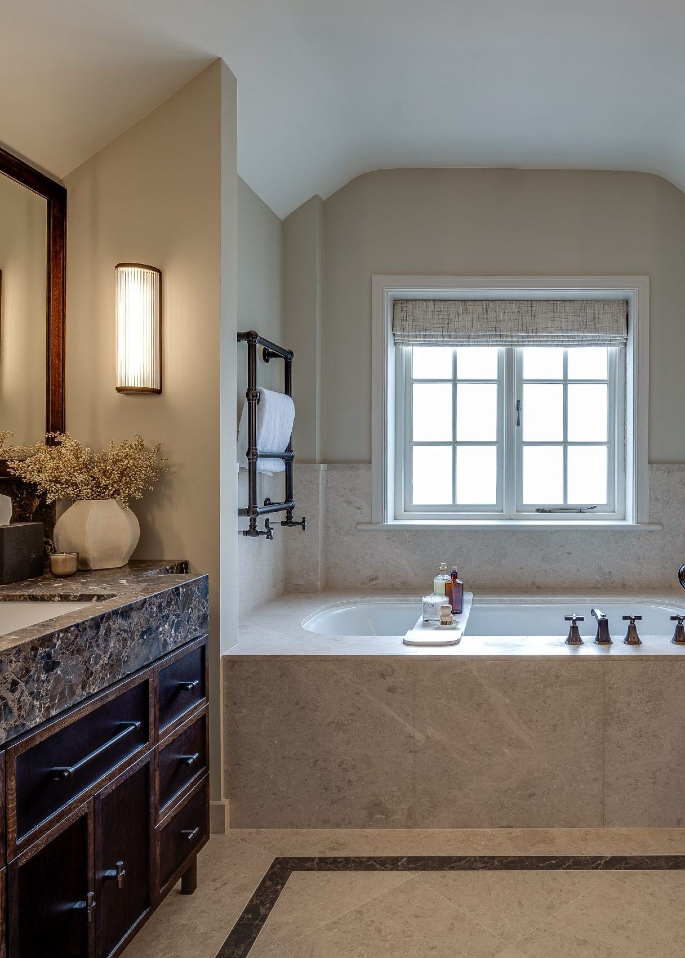 Master bathroom with marble vanity, double mirror and built-in stone bath surround
