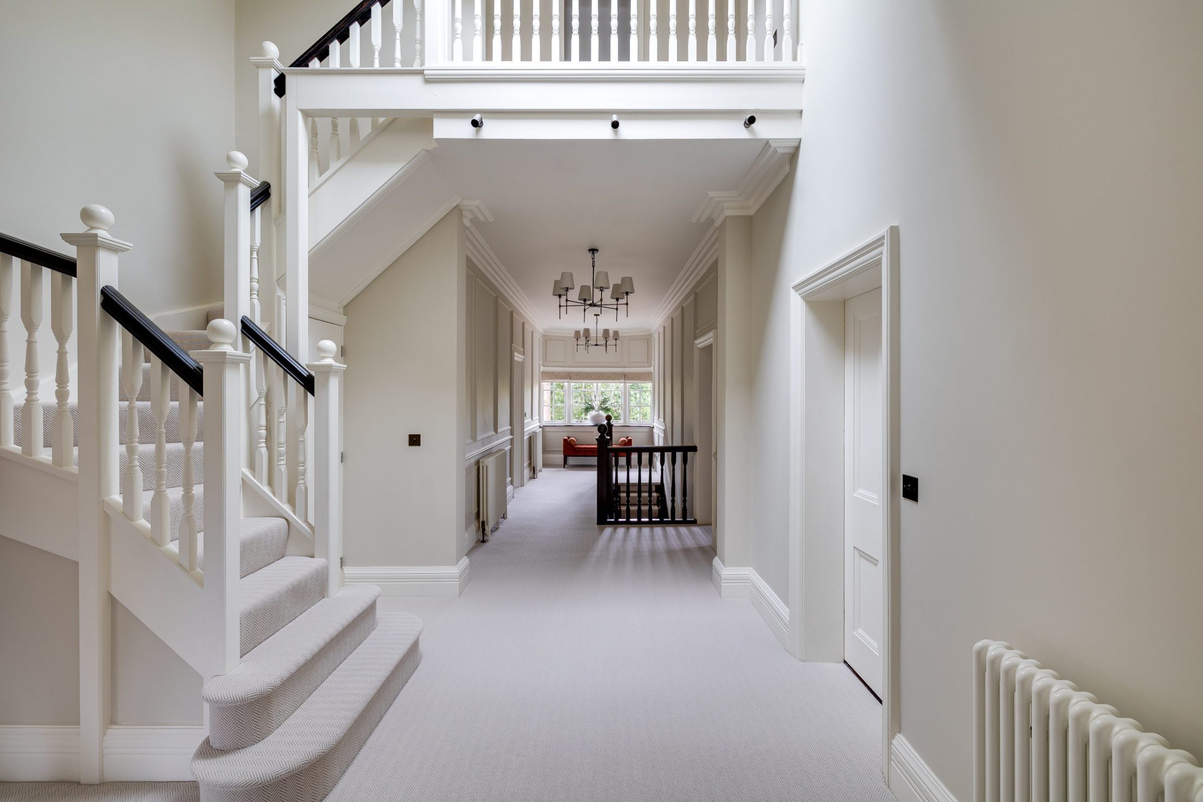 Upper landing with double staircase and classic white balustrade detail